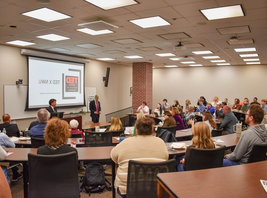 Chance Hergott and Zach Weiss present to a group of people. 